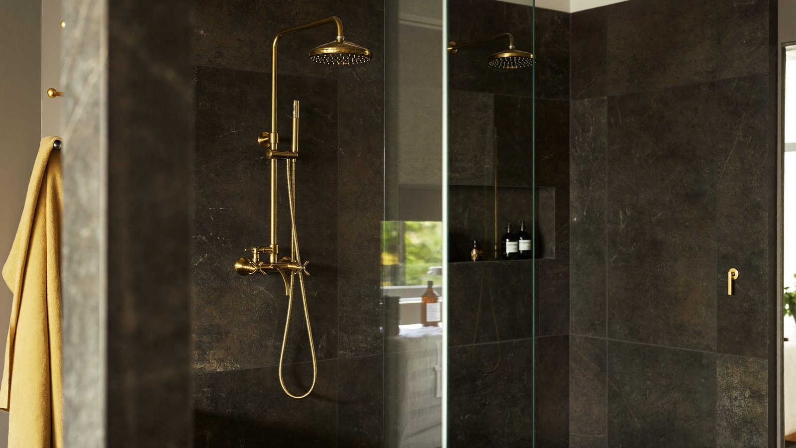 A finished bathroom plumbed by SFR, dark slate and warm light